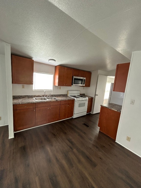 1406 East Wallisville Road Highlands, TX 77562 - Photo 16 of 26 a kitchen with stainless steel appliances granite countertop a stove a sink and a refrigerator