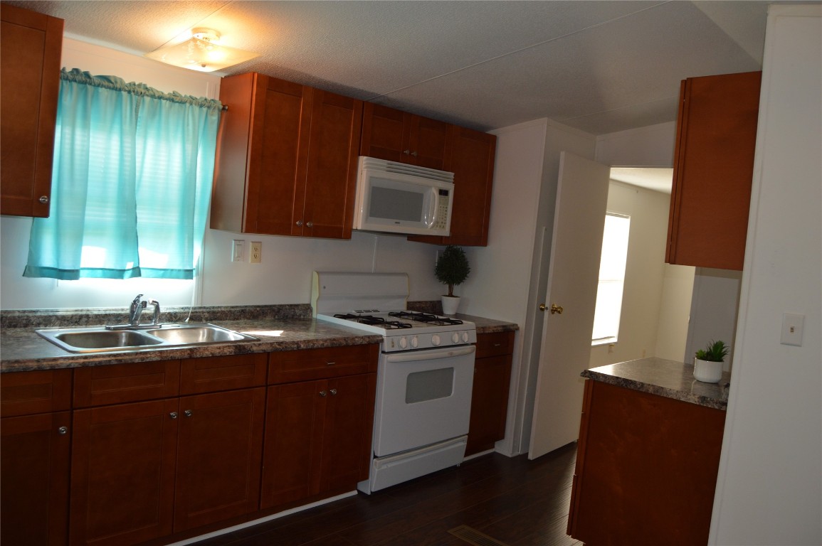 1406 East Wallisville Road Highlands, TX 77562 - Photo 2 of 26 a kitchen with a sink stove and cabinets