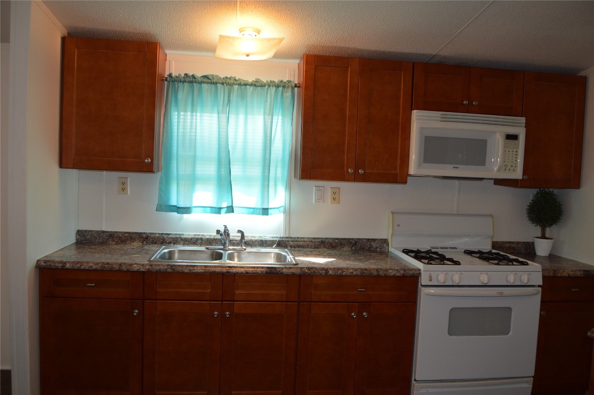 1406 East Wallisville Road Highlands, TX 77562 - Photo 3 of 26 a kitchen with a sink a stove and cabinets