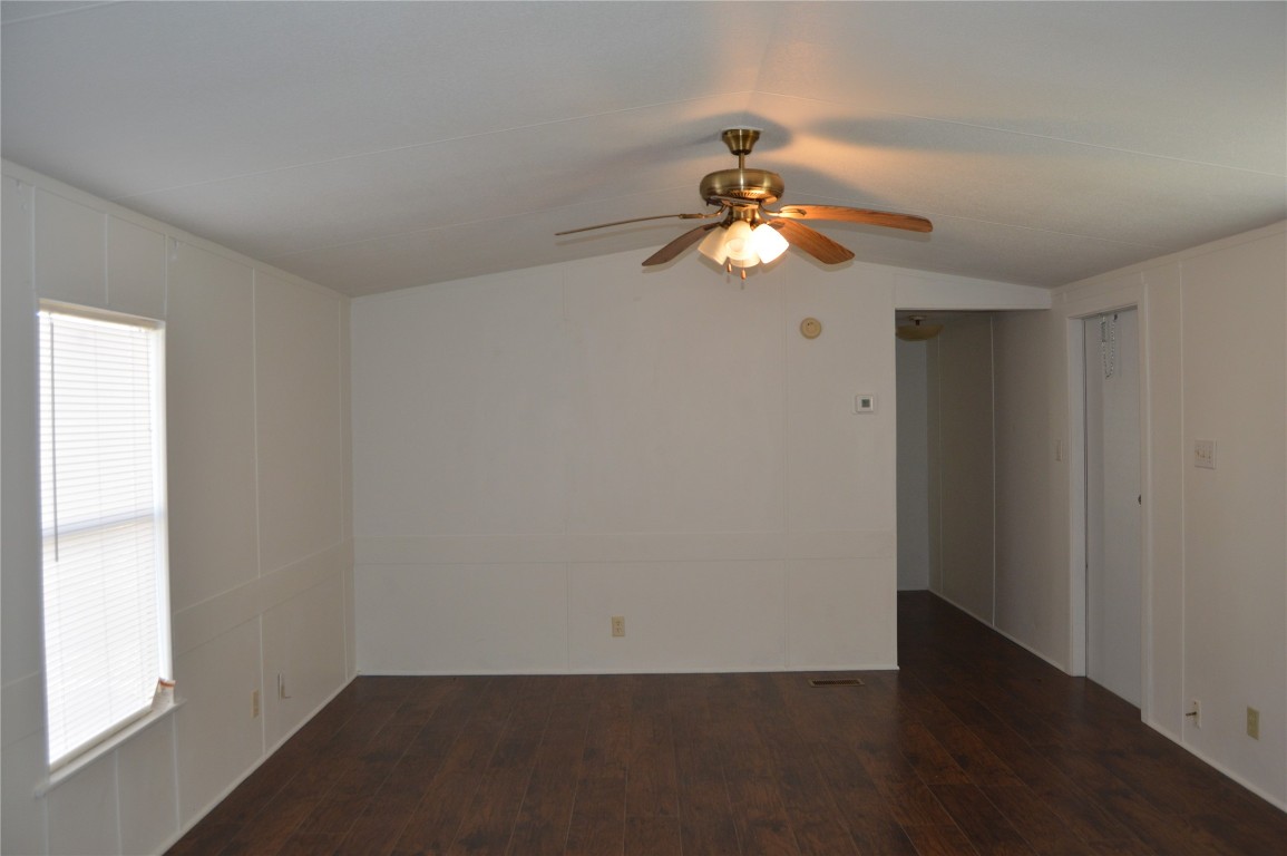 1406 East Wallisville Road Highlands, TX 77562 - Photo 4 of 26 wooden floor in an empty room with a window