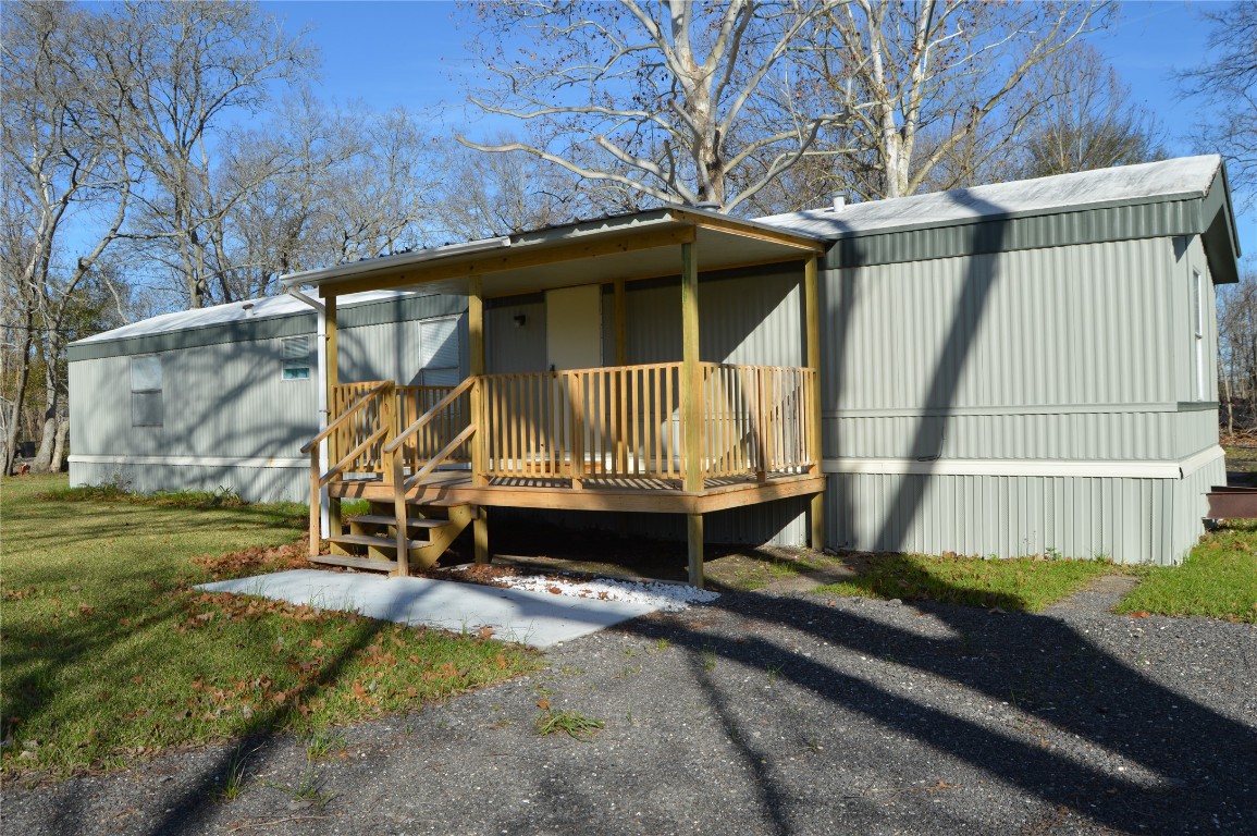 1406 East Wallisville Road Highlands, TX 77562 - Photo 7 of 26 a house with trees in the background