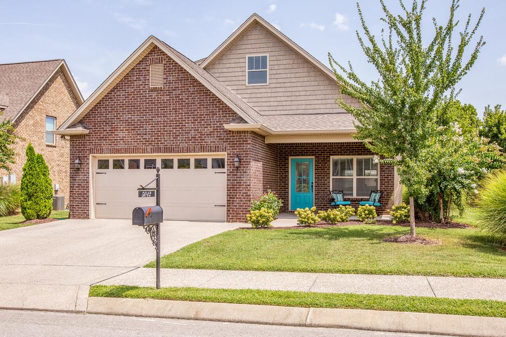 5012 Geranium Drive Spring Hill, TN 37174 - Photo 1 of 26 a front view of a house with a yard table and chairs