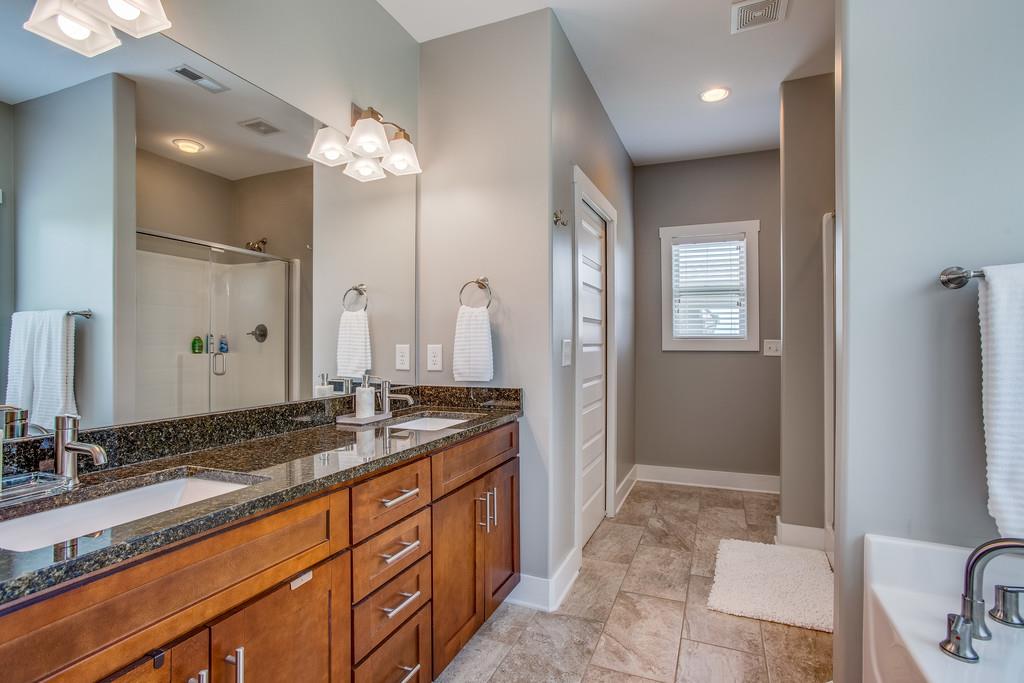 5012 Geranium Drive Spring Hill, TN 37174 - Photo 14 of 26 a spacious bathroom with a granite countertop sink a mirror and a shower
