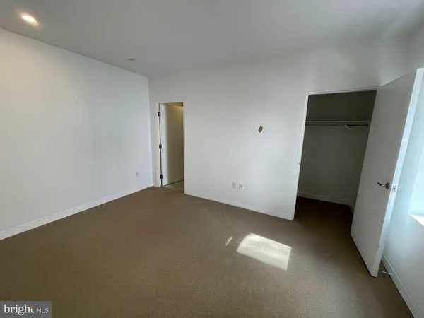 a view of an empty room and a window