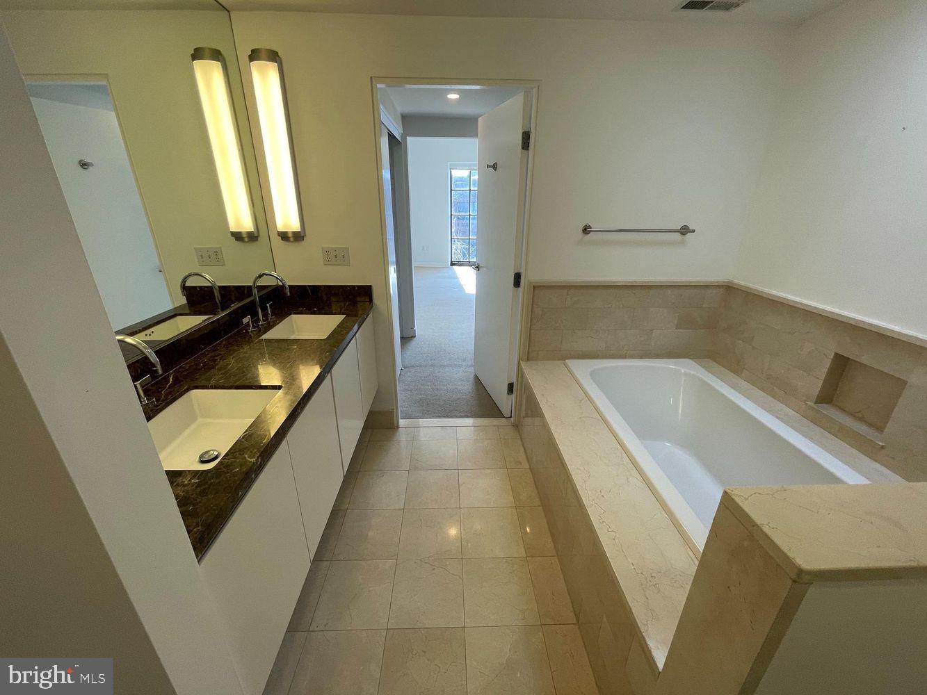 3336 Cady's Alley Northwest, Unit 201 Washington, DC 20007 - Photo 17 of 34 a bathroom with a tub sink and mirror