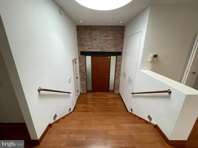 a bathroom with a granite countertop toilet a sink and a mirror