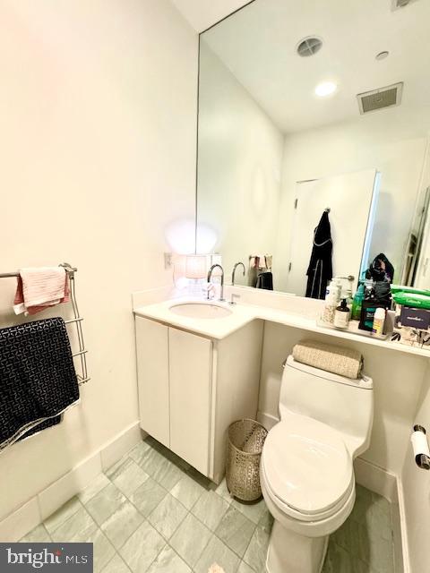 3336 Cady's Alley Northwest, Unit 201 Washington, DC 20007 - Photo 24 of 34 a bathroom with a toilet sink and mirror