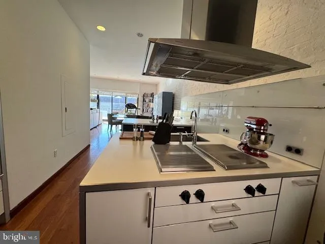 a kitchen with a sink cabinets and wooden floor