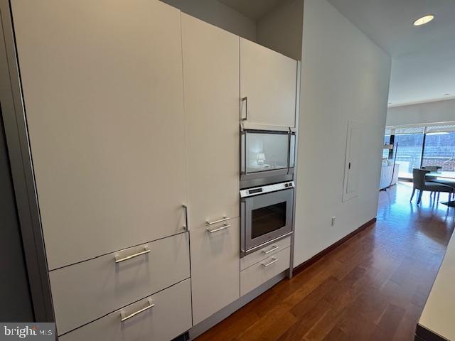 3336 Cady's Alley Northwest, Unit 201 Washington, DC 20007 - Photo 31 of 34 a kitchen with cabinets and wooden floor