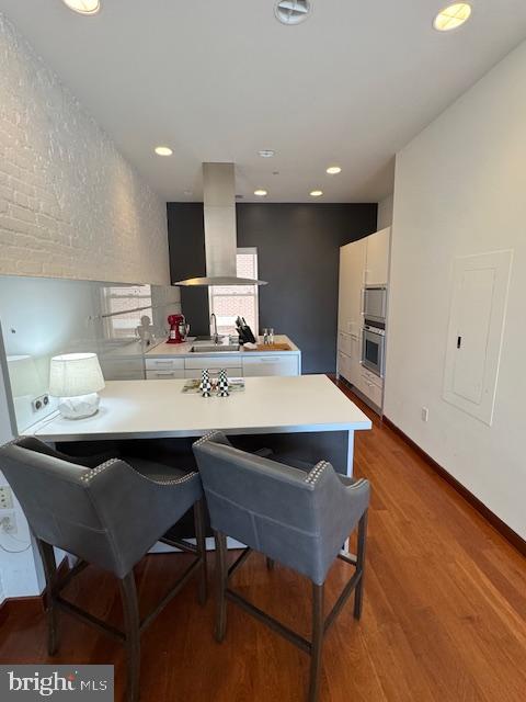 3336 Cady's Alley Northwest, Unit 201 Washington, DC 20007 - Photo 33 of 34 a kitchen with a sink cabinets and wooden floor