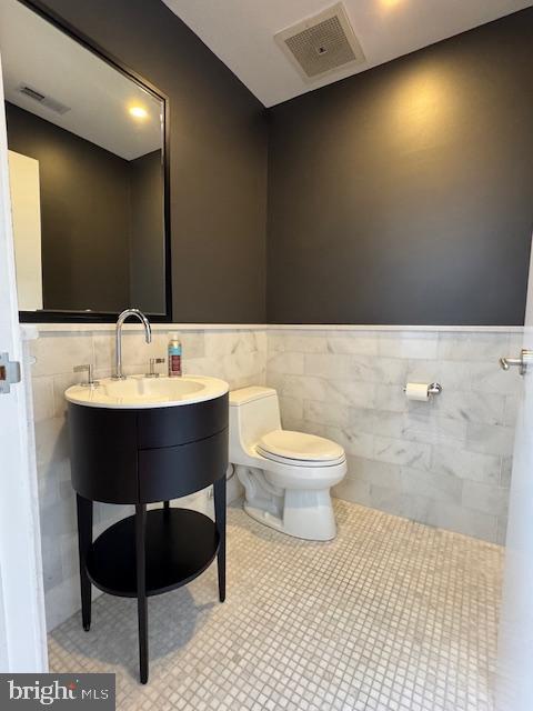 3336 Cady's Alley Northwest, Unit 201 Washington, DC 20007 - Photo 6 of 34 a bathroom with a sink a toilet and mirror