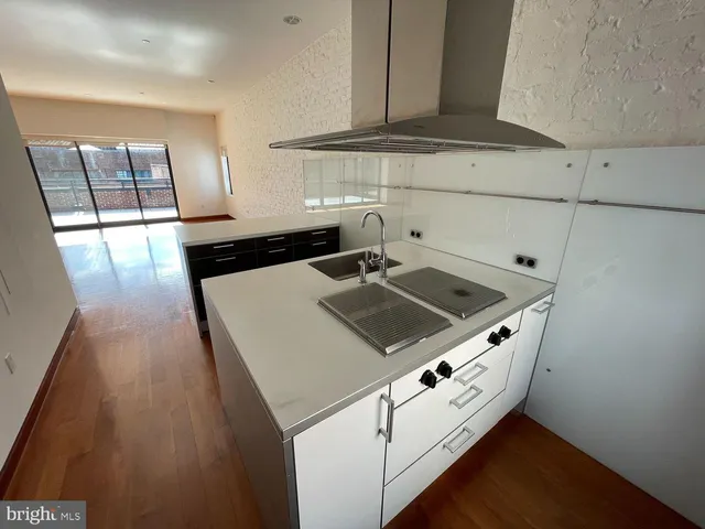 a kitchen with a sink appliances and cabinets