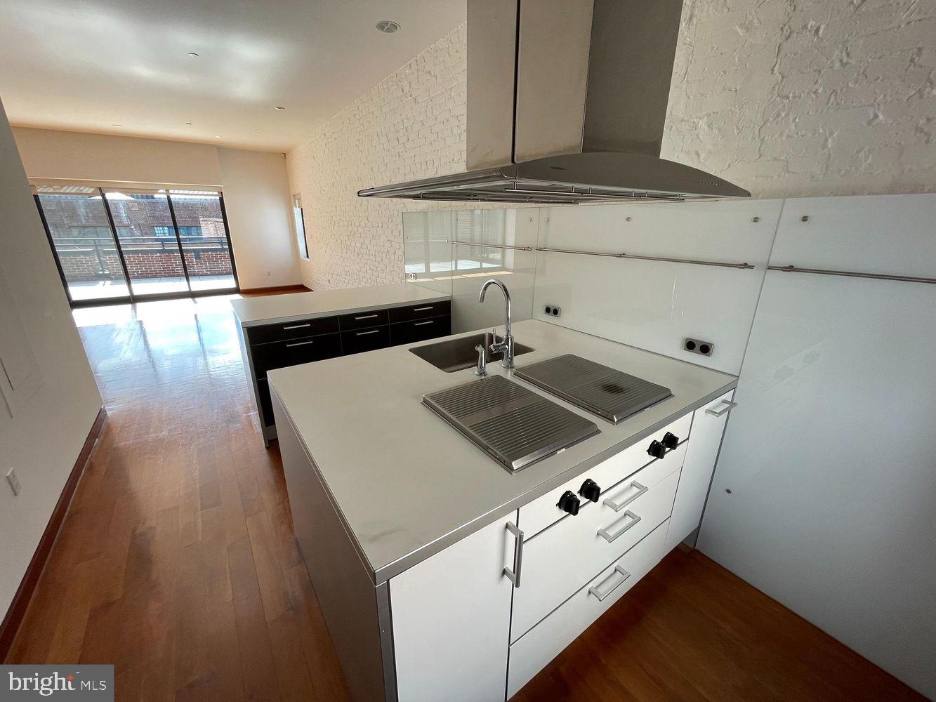 3336 Cady's Alley Northwest, Unit 201 Washington, DC 20007 - Photo 7 of 34 a kitchen with granite countertop a stove and a sink