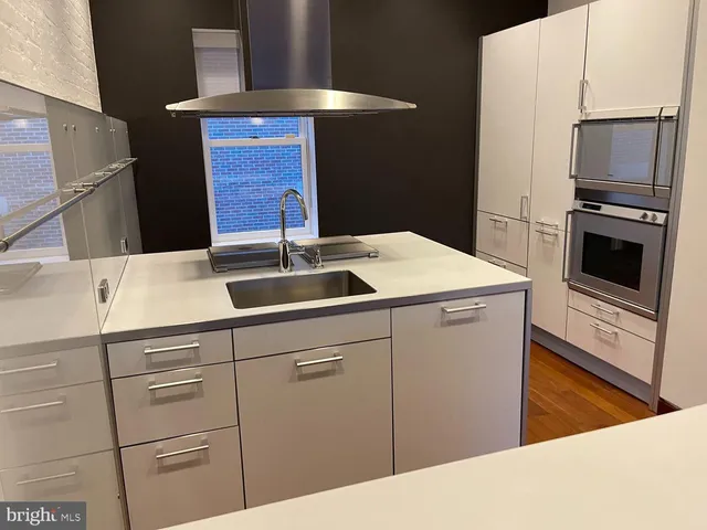 a kitchen that has a sink and a stove