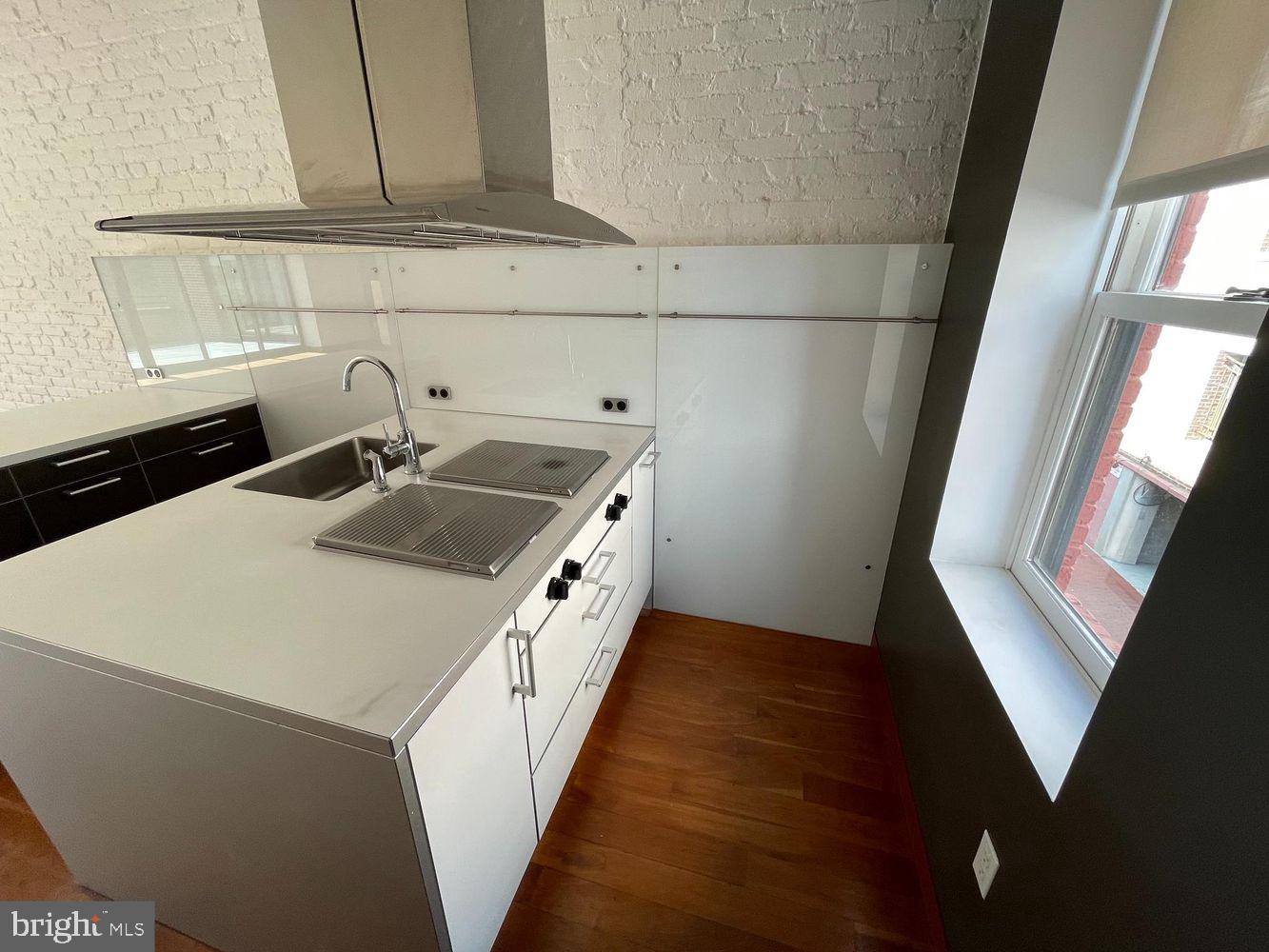 3336 Cady's Alley Northwest, Unit 201 Washington, DC 20007 - Photo 9 of 34 a kitchen that has a sink and a stove