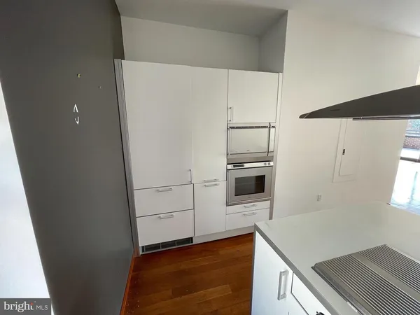 a kitchen with kitchen island a sink stainless steel appliances and cabinets