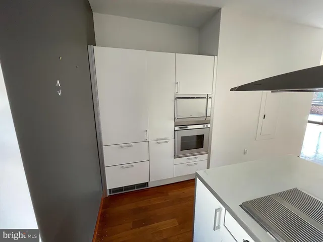 a kitchen with kitchen island a sink stainless steel appliances and cabinets