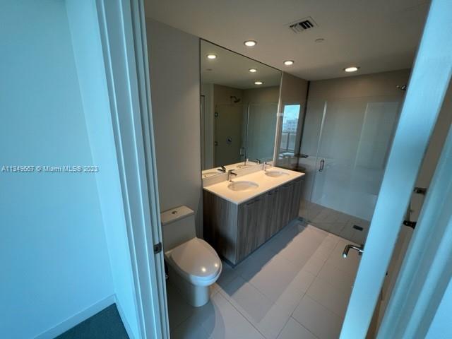 Edgewater Miami, FL 33137 - Photo 15 of 65 a bathroom with a sink a toilet and vanity