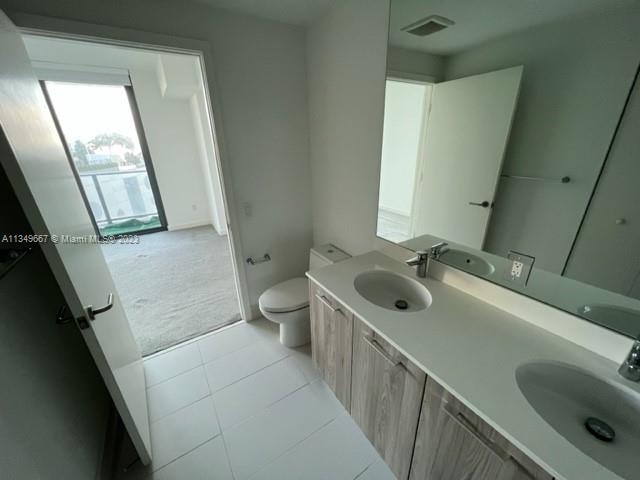 Edgewater Miami, FL 33137 - Photo 17 of 65 a bathroom with a sink a toilet and a tub
