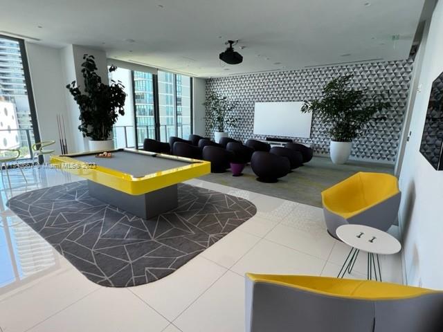 Edgewater Miami, FL 33137 - Photo 42 of 65 a living room with furniture and a flat screen tv