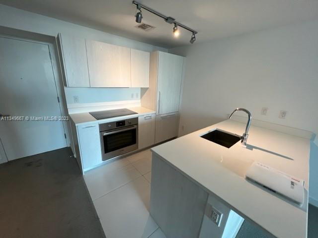 Edgewater Miami, FL 33137 - Photo 5 of 65 a kitchen with a sink and a stove