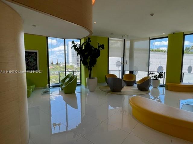 Edgewater Miami, FL 33137 - Photo 57 of 65 a living room with furniture a potted plant and a large window