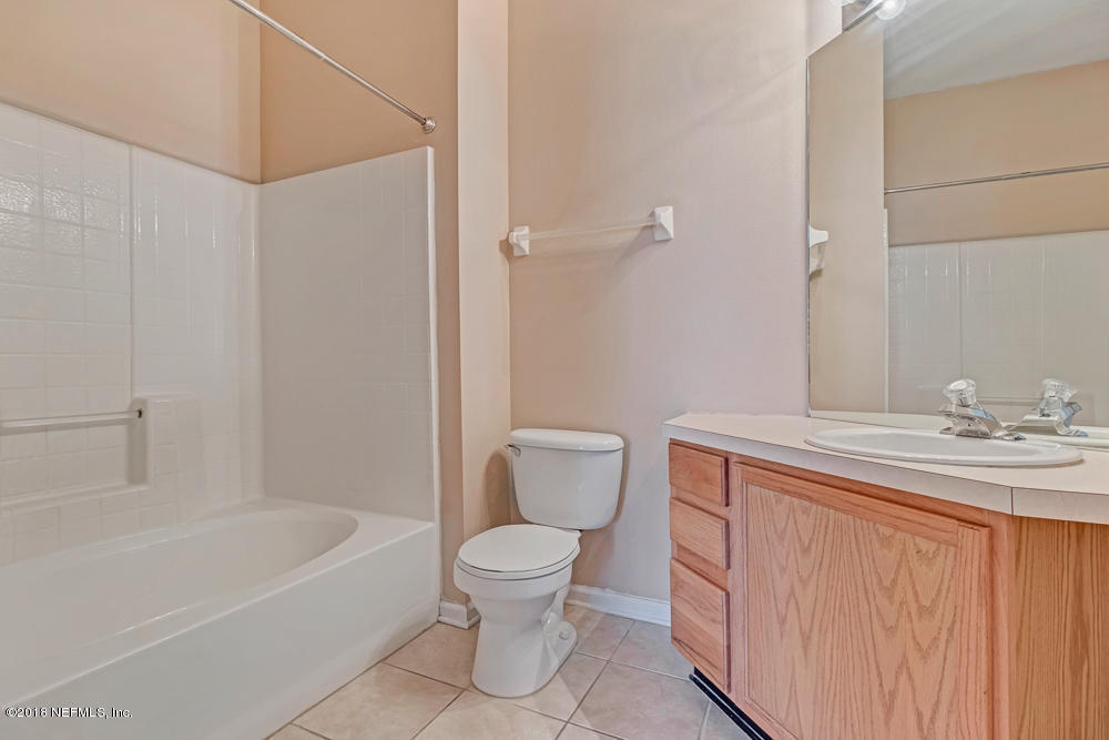 7990 Baymeadows Road East, Unit 211 Jacksonville, FL 32256 - Photo 13 of 21 a bathroom with a sink a toilet and shower