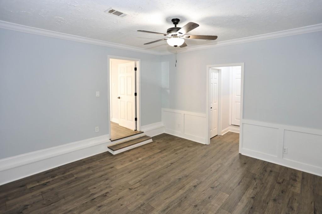 1508 Peachcrest Road Decatur, GA 30032 - Photo 17 of 26 an empty room with wooden floor and ceiling fan