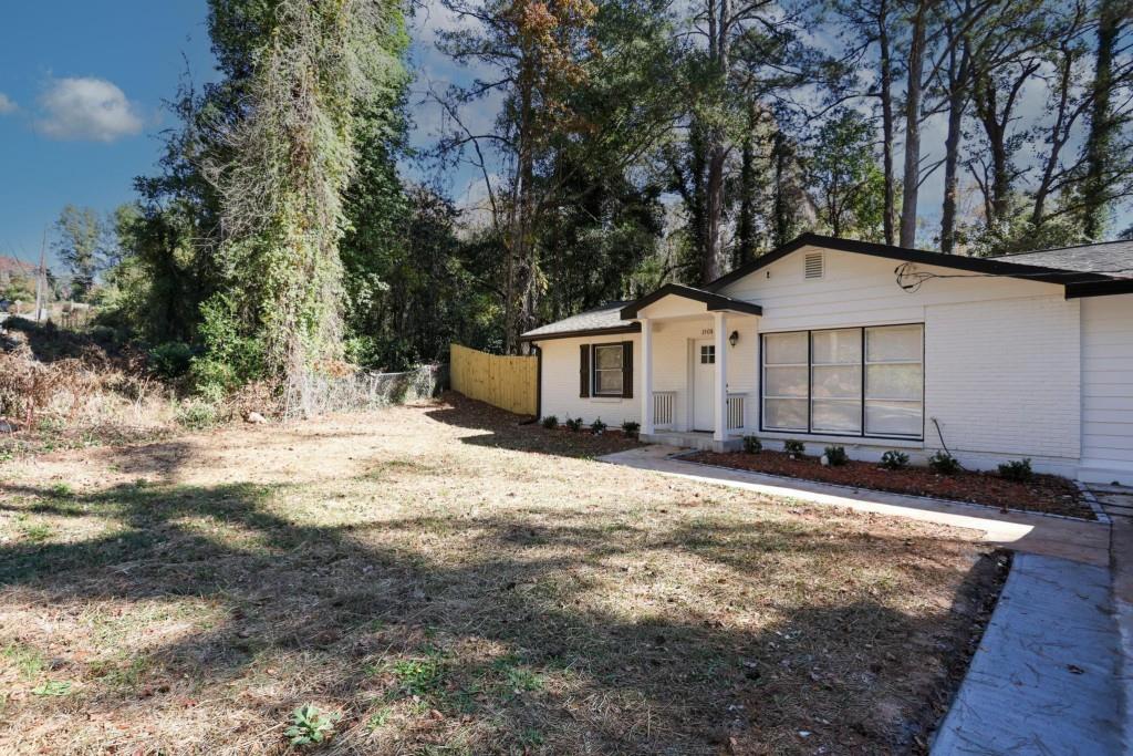 1508 Peachcrest Road Decatur, GA 30032 - Photo 2 of 26 a front view of a house with a yard covered with trees