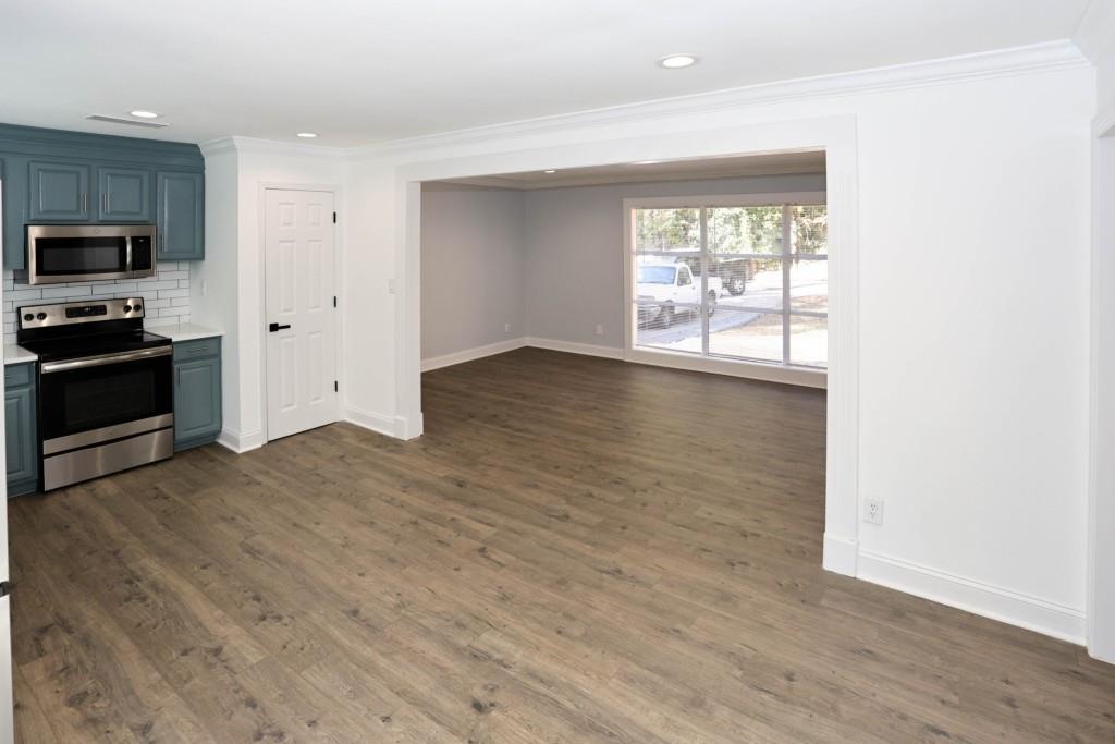 1508 Peachcrest Road Decatur, GA 30032 - Photo 10 of 26 a view of an empty room with a window and wooden floor
