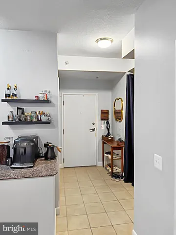a kitchen with stainless steel appliances granite countertop a refrigerator and a stove