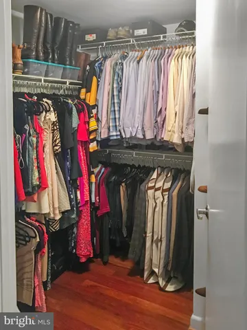 a view of walk in closet with clothes