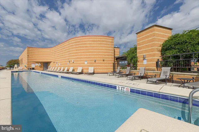 a view of swimming pool with outdoor seating