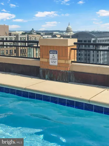 a view of a swimming pool with an outdoor seating