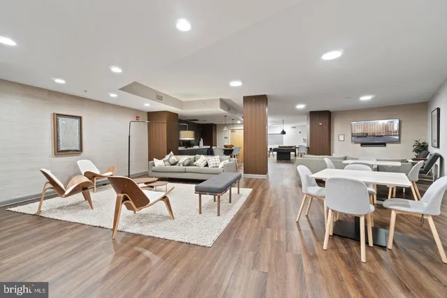 a view of a dining room with furniture wooden floor and a kitchen