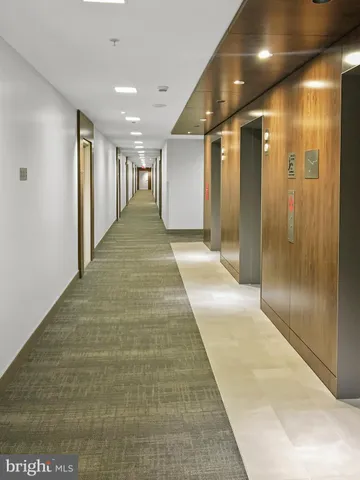 a view of hallway with a bathroom
