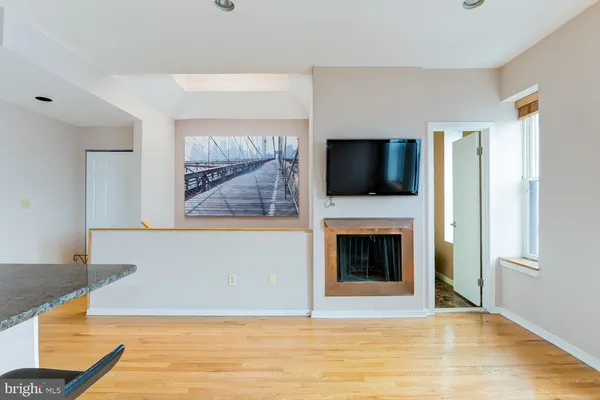 a view of a livingroom with an empty space and a fireplace