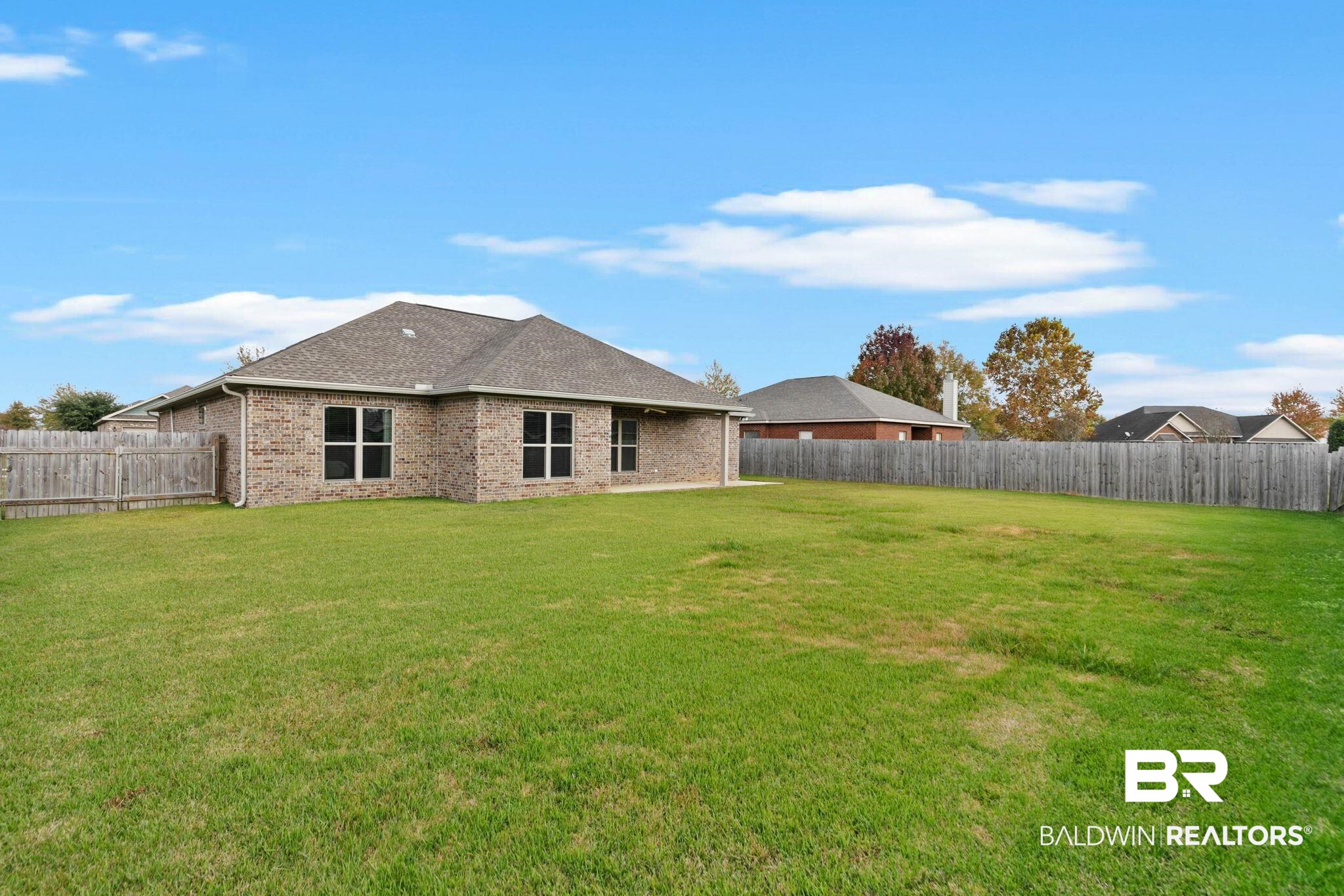 9388 Pembrook Loop Fairhope, AL 36532 - Photo 48 of 53 Rear view of property with a fenced backyard, brick siding, roof with shingles, and a patio area