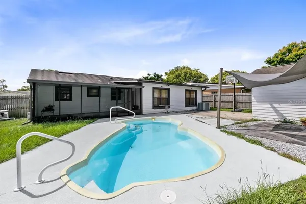 a house view with a swimming pool and porch