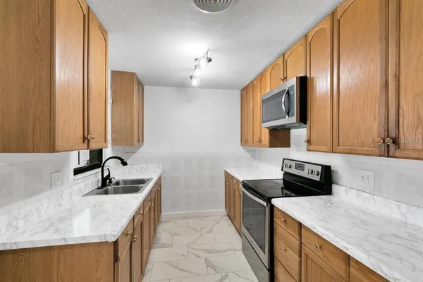 a kitchen with a sink and a refrigerator