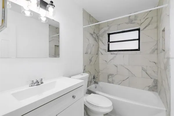 a bathroom with a sink a toilet and bathtub