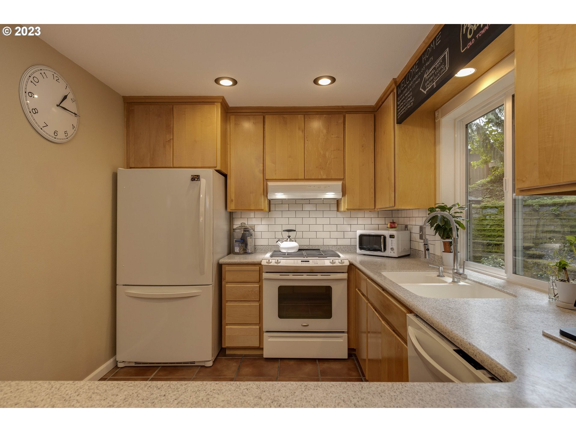 9732 Southwest 18th Place Portland, OR 97219 - Photo 16 of 45 a kitchen with a refrigerator sink and cabinets