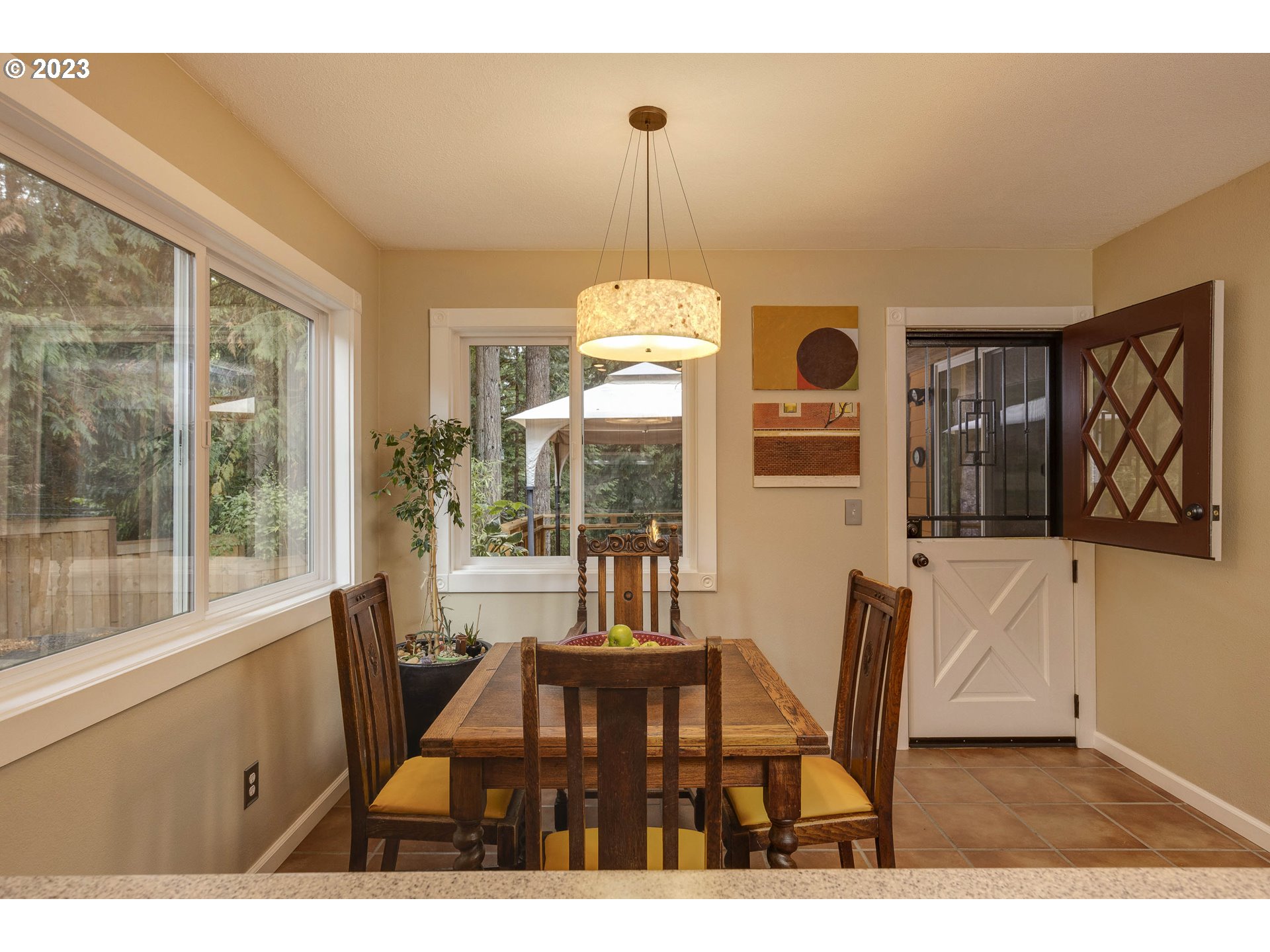 9732 Southwest 18th Place Portland, OR 97219 - Photo 18 of 45 a dining room with furniture a chandelier and wooden floor