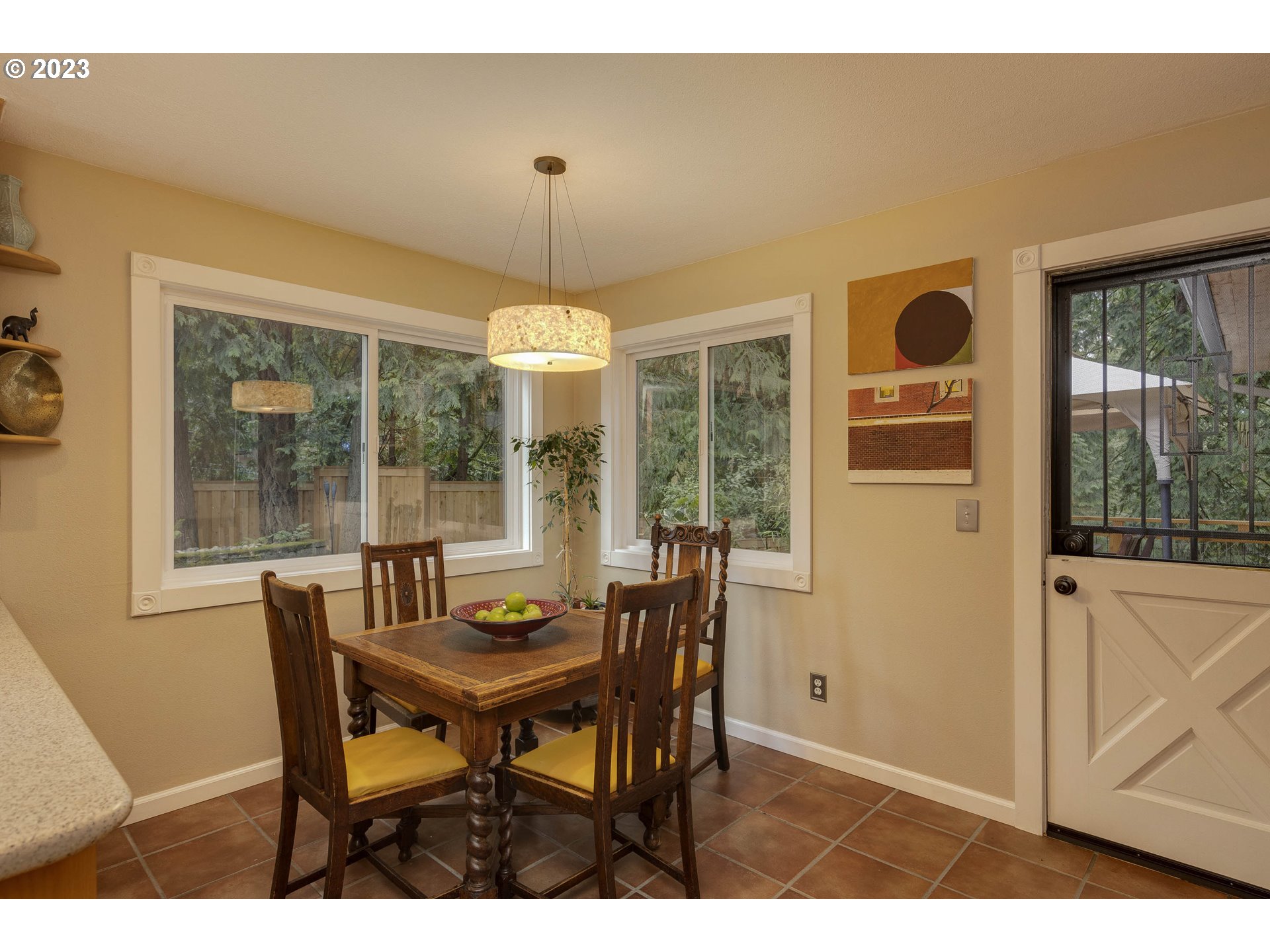 9732 Southwest 18th Place Portland, OR 97219 - Photo 19 of 45 a view of a dining room with furniture wooden floor and chandelier