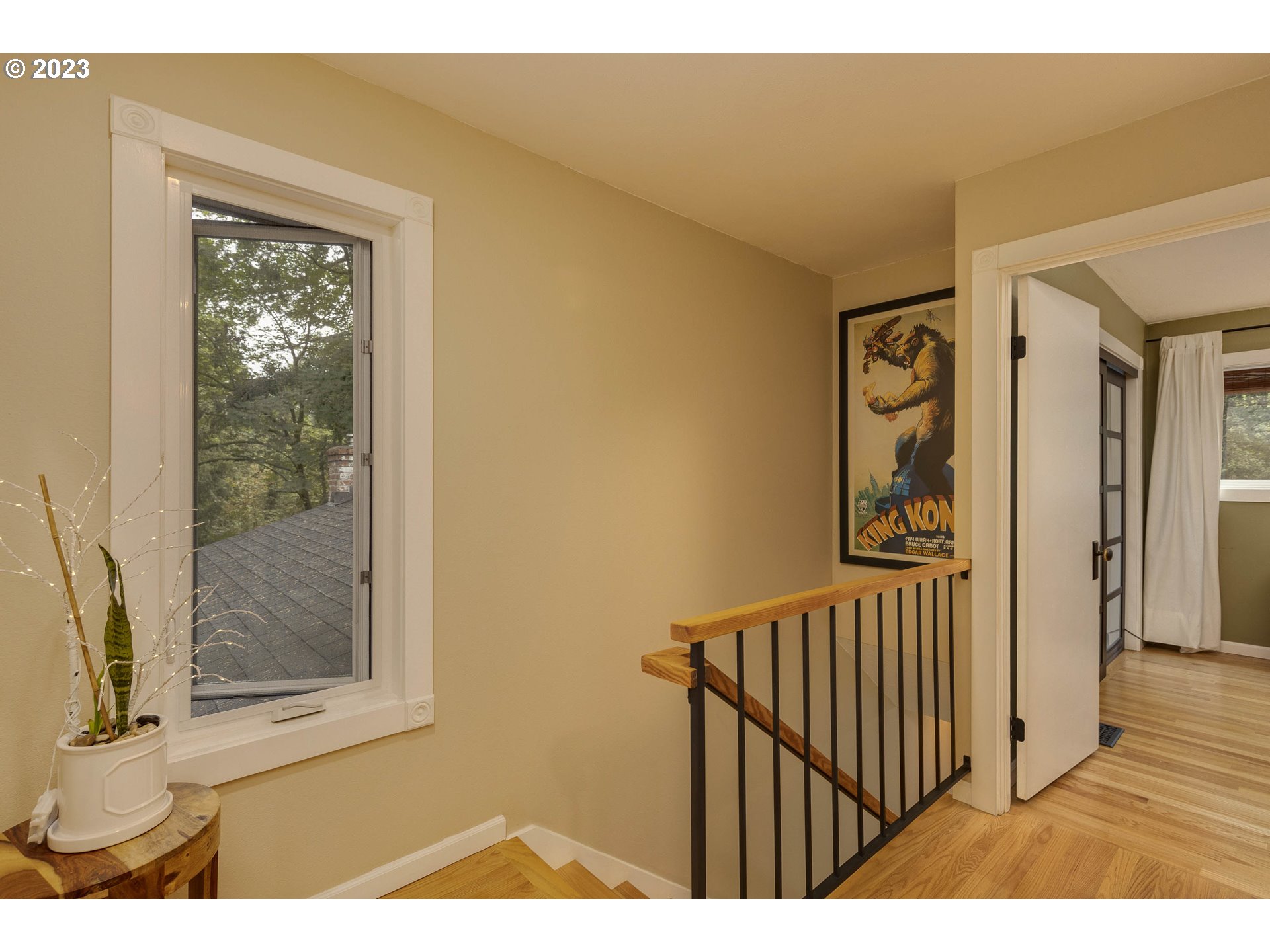 9732 Southwest 18th Place Portland, OR 97219 - Photo 22 of 45 a view of a hallway with wooden floor and a living room