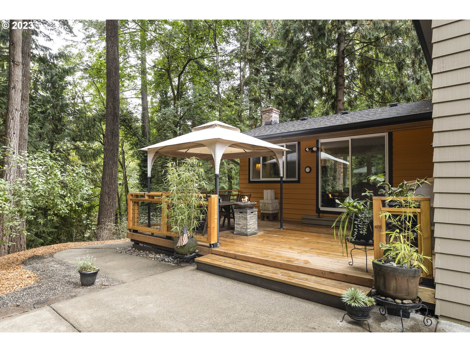 9732 Southwest 18th Place Portland, OR 97219 - Photo 33 of 45 a backyard of a house with barbeque oven and outdoor seating