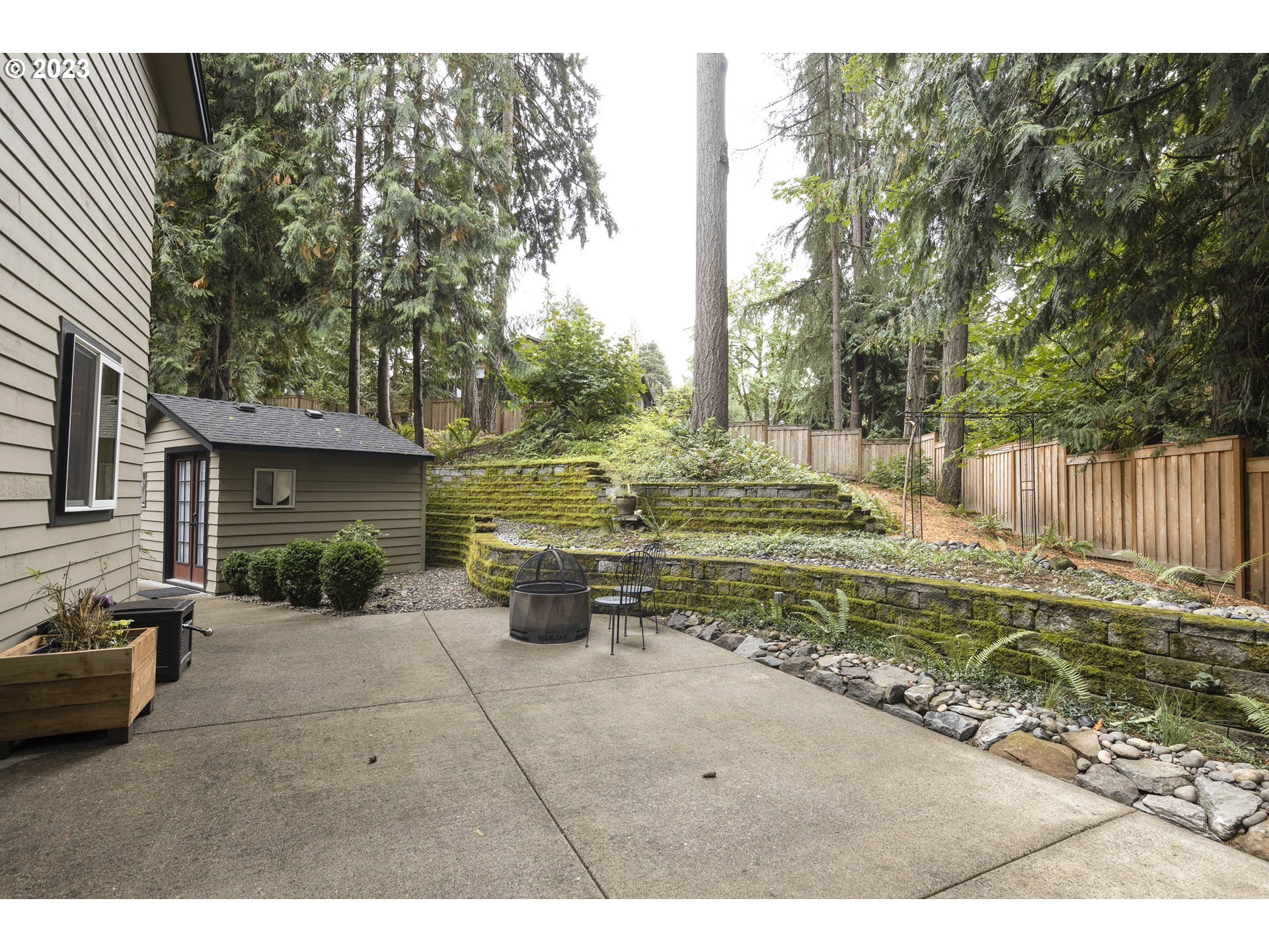 9732 Southwest 18th Place Portland, OR 97219 - Photo 36 of 45 a view of a backyard with table and chairs