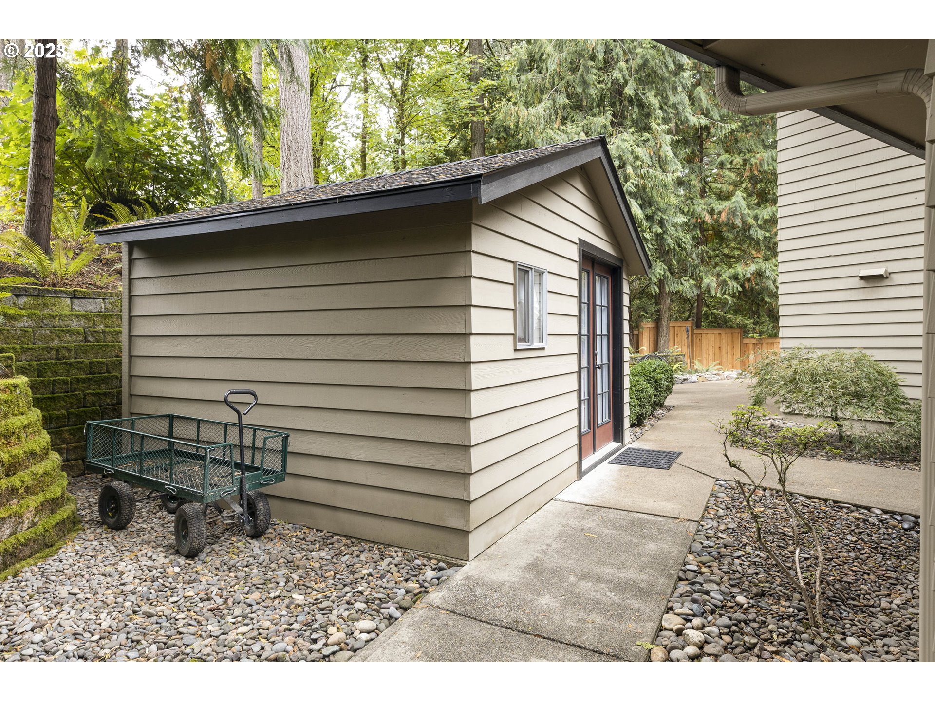 9732 Southwest 18th Place Portland, OR 97219 - Photo 39 of 45 a view of a house with a yard chairs and floor to ceiling window