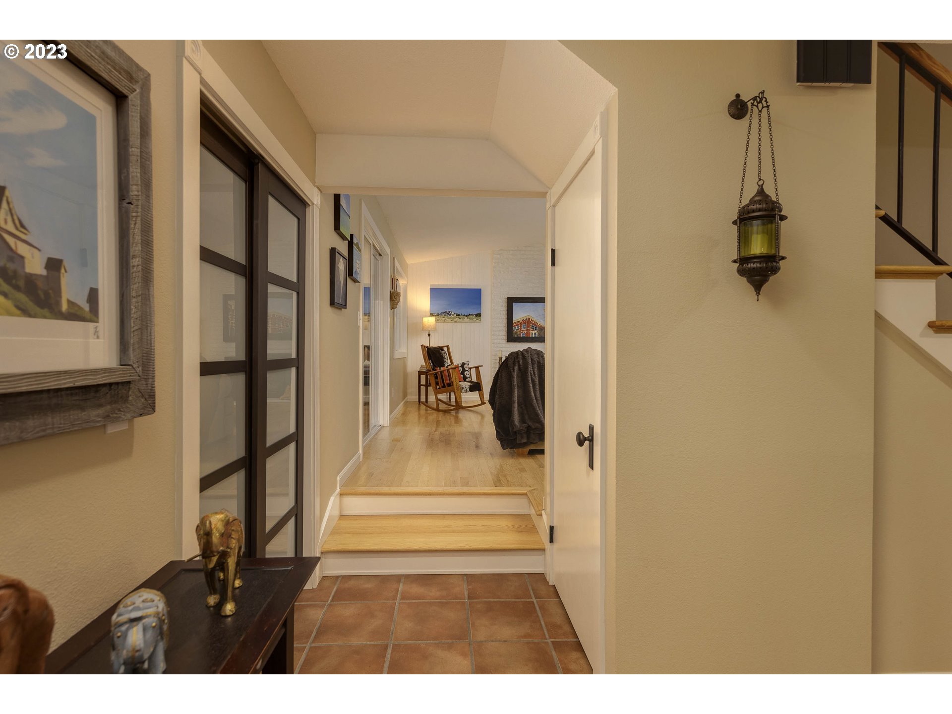 9732 Southwest 18th Place Portland, OR 97219 - Photo 10 of 45 a view of a hallway with a white house and wooden floor
