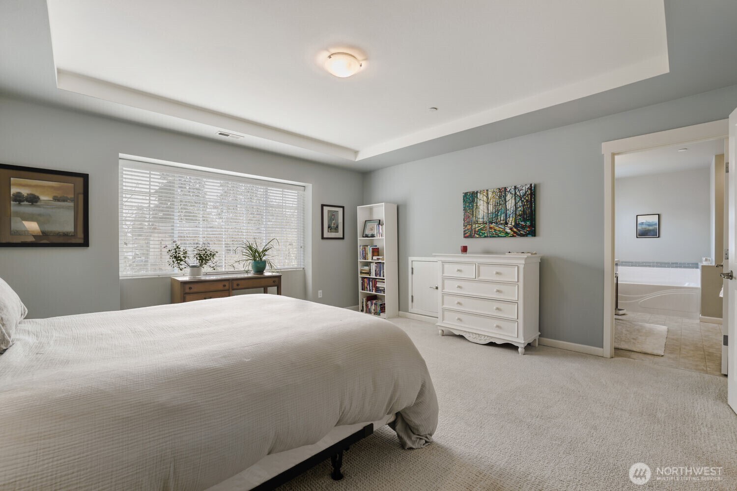 18705 101st Avenue Northeast, Unit 3 Bothell, WA 98011 - Photo 21 of 31 a bedroom with a large bed and dresser